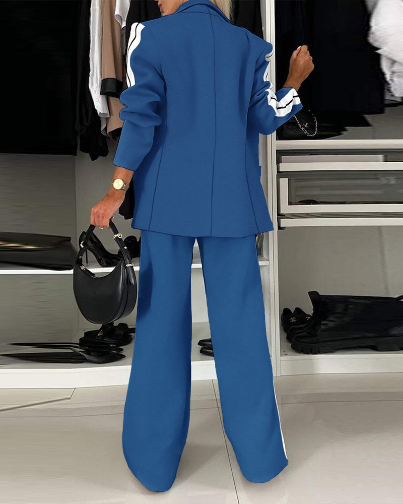 LA FINE FLEUR notched collar blazer with white sleeve stripes and matching wide-leg pants.