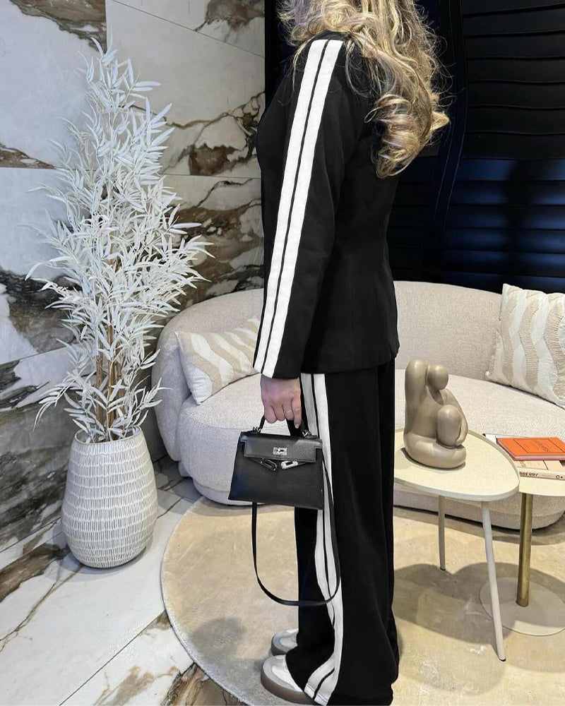 LA FINE FLEUR notched collar blazer with white stripes and matching wide-leg pants set.