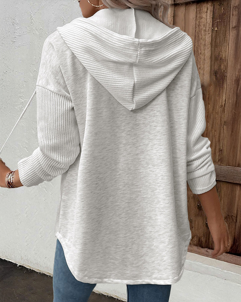 Long sleeve ribbed button-front hoodie with asymmetrical hem coat in light gray and blue jeans.
