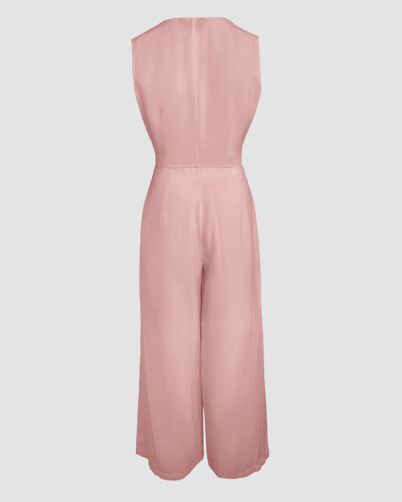 Light pink V-neck crop vest and wide-leg pants with fitted waist and flowing silhouette.