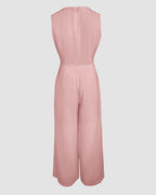 Light pink V-neck crop vest and wide-leg pants with fitted waist and flowing silhouette.