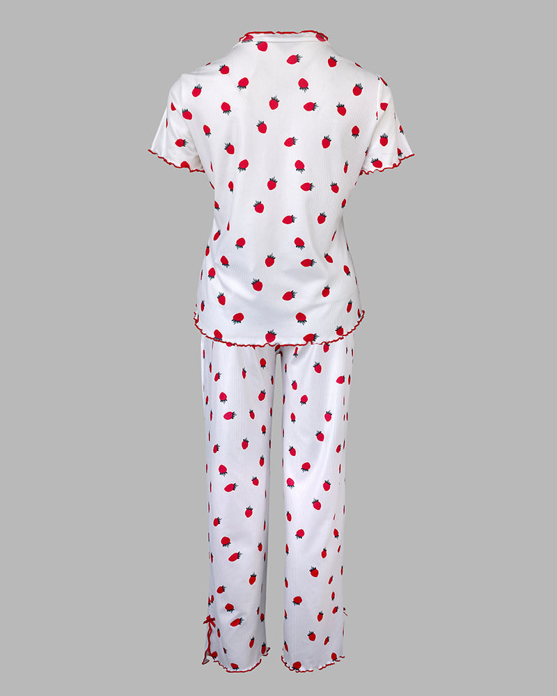 Short-sleeve stand collar tee and long pants pajama set with strawberry print and red ruffled trim.