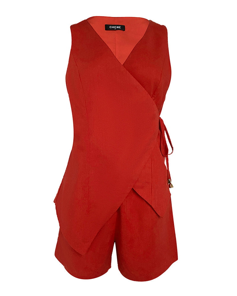 Sleeveless linen wrap top with V-neckline and side tie, paired with pocketed shorts.