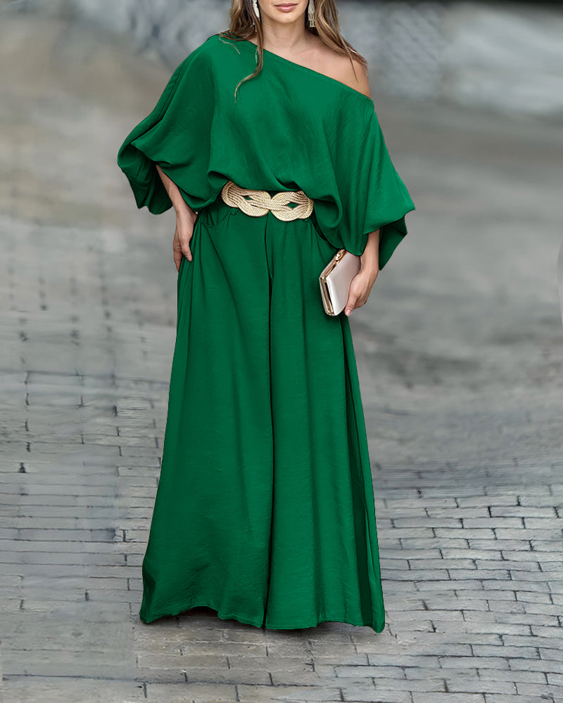 A LA FINE FLEUR skew neck lantern sleeve blouse paired with wide leg pants set.