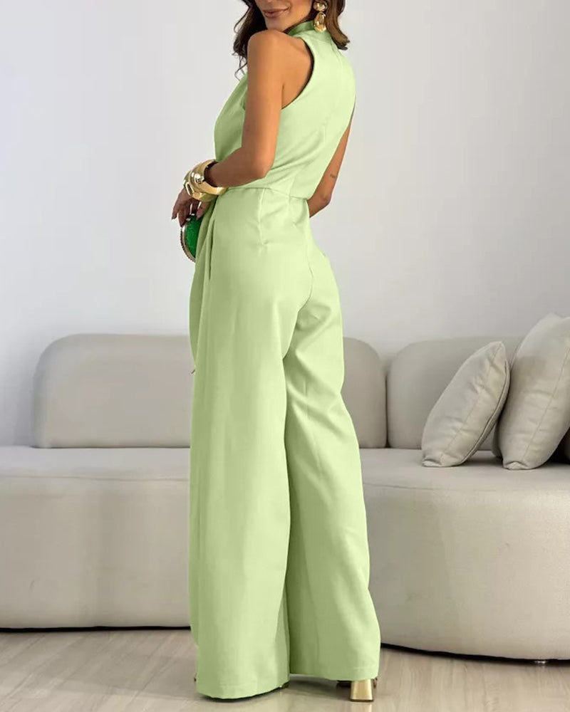 Light green halter sleeveless ruched jumpsuit with zip-back, tie-waist, and wide legs.