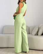 Light green halter sleeveless ruched jumpsuit with zip-back, tie-waist, and wide legs.