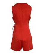 Sleeveless fitted linen wrap top with waist tie and loose pocketed shorts, both textured.
