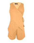 Sleeveless light orange linen wrap top with side tie, V-neck, and matching pocketed shorts.