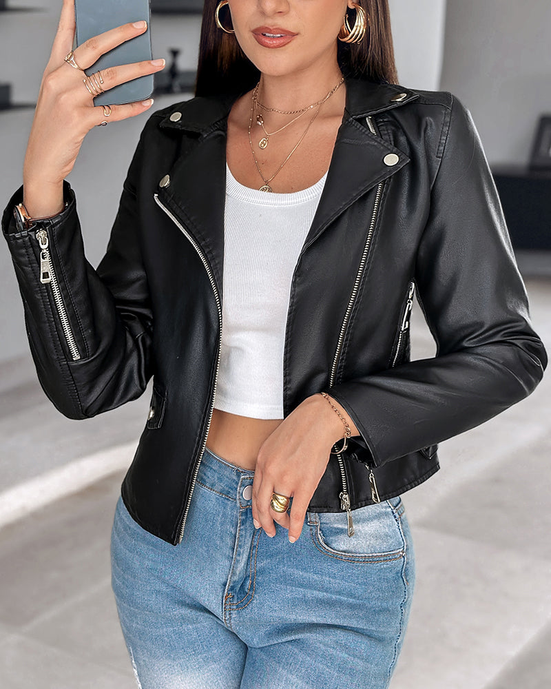 LA FINE FLEUR  PU leather zipper biker jacket with notched collar over a white crop top and blue jeans.