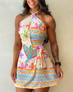 Tropical print halter backless tie-back romper with wrap skorts, floral and geometric patterns.