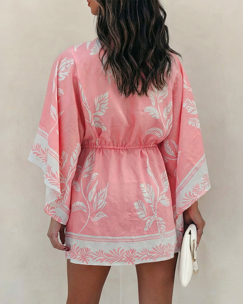 A floral V-neck mini dress with bell sleeves and a drawstring waist.