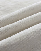 White cotton V-neck crop vest top and wide-leg pants, textured weave with speckled details.