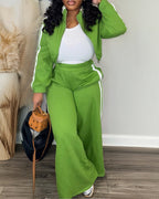 Bright green zip-up crop coat and wide-leg pants with white stripes, paired with a white top.