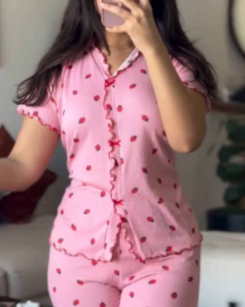 Pink strawberry print pajama set with red trim, featuring a stand collar tee and pants.