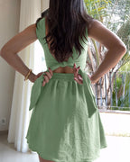 A square-neck, thick-strap textured romper with tie-back skorts in a stylish design.
