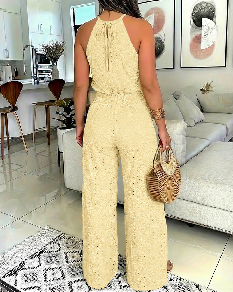 A 2-piece halter top and slit pants set with intricate guipure lace detailing.