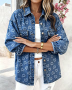 LA FINE FLEUR  Vintage Heart Jacquard Denim Jacket with asymmetrical hem over white crop top and pants.