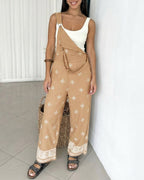 The LA FINE FLEUR vintage embroidered tribal suspender jumpsuit with undone strap over white tank.