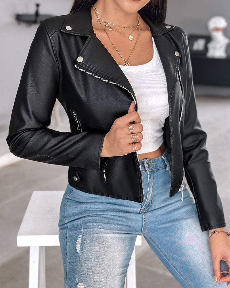 A black PU leather zipper biker jacket with notched collar over a white ribbed crop top and light blue distressed jeans.