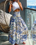 LA FINE FLEUR’s Vintage Floral Shirred Wide-Leg High-Waist Pants and a sleeveless white crop top.