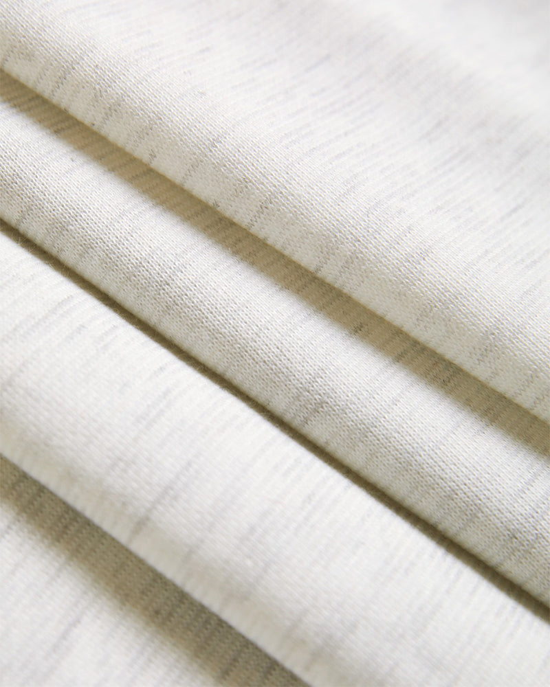 Light beige, heathered ribbed hoodie with soft horizontal lines and an asymmetrical hem.