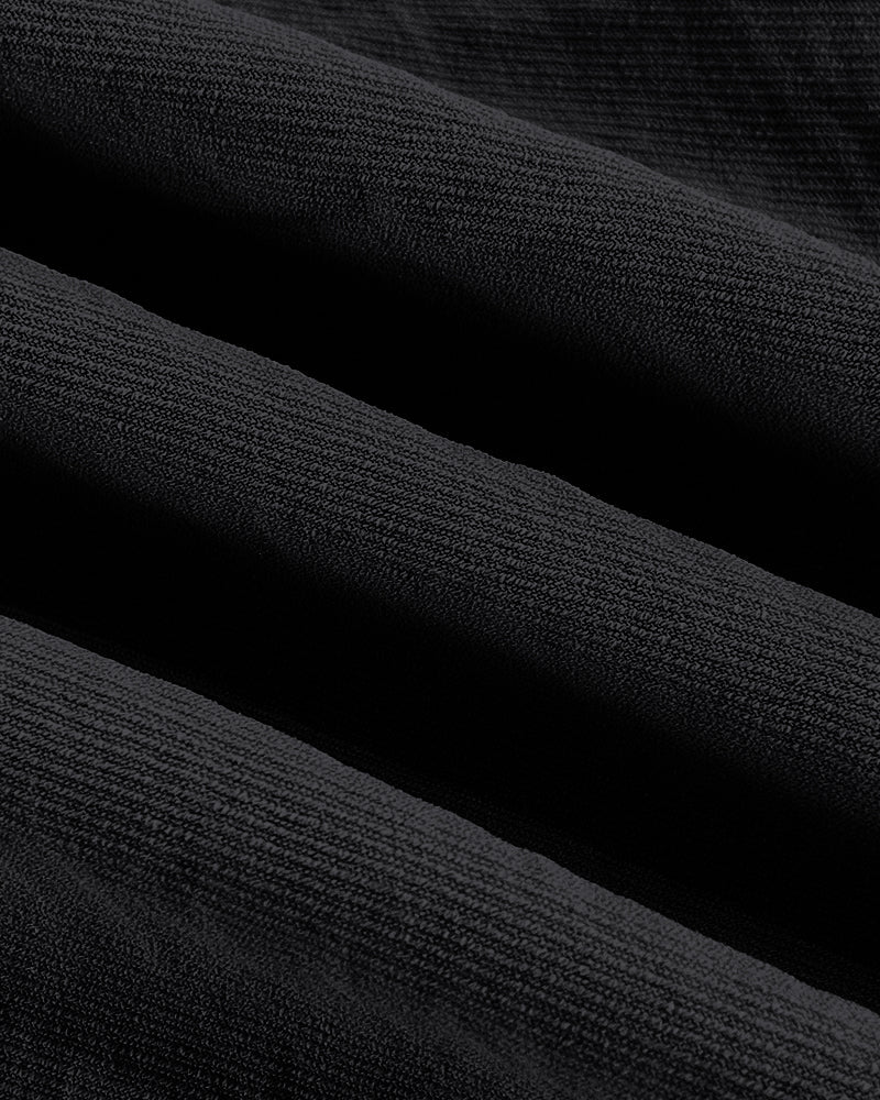 Close-up of blouse and wide leg pants set fabric, rich black texture and woven detail.