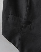 V-neck vest crop top with wide-leg pants, featuring detailed pocket stitching and textured fabric.