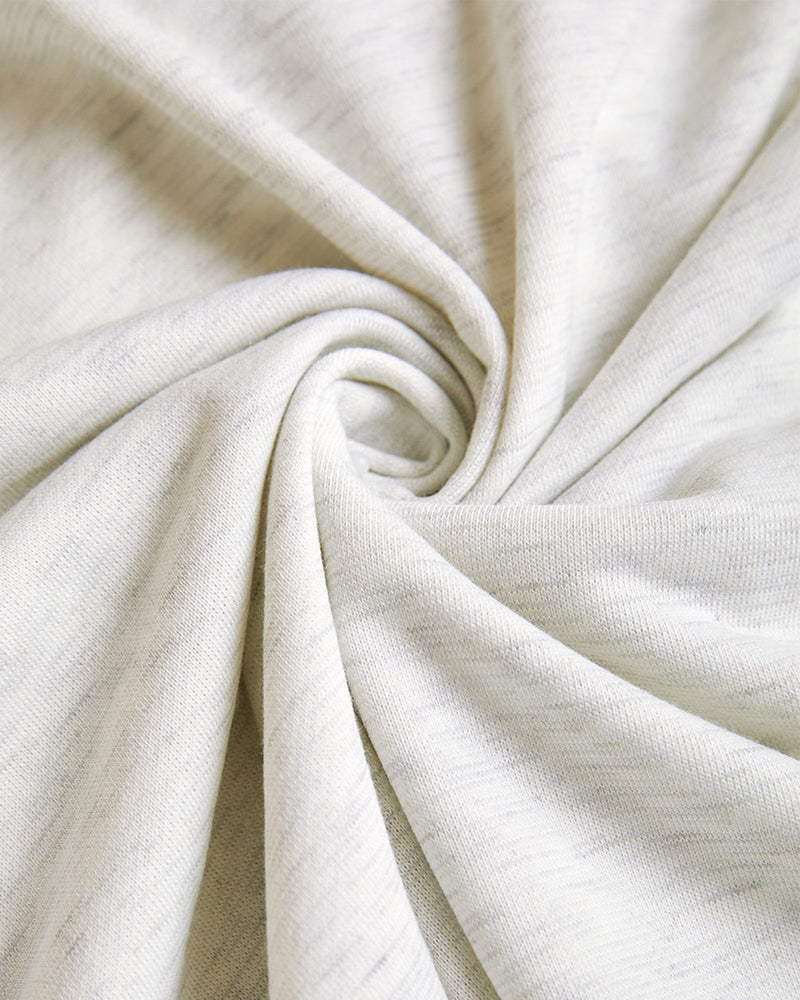 Light gray, ribbed hoodie coat fabric twisted to show smooth texture and heathered pattern.