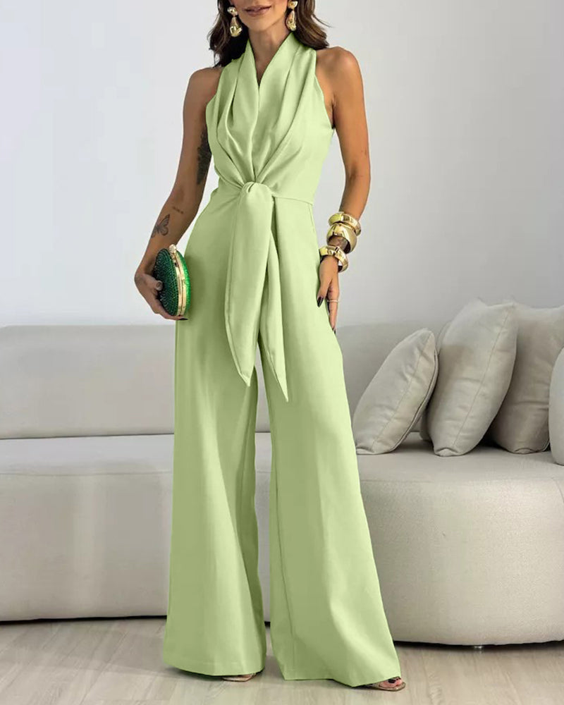 LA FINE FLEUR halter sleeveless ruched zip-back tie-waist wide-leg jumpsuit shown indoors.
