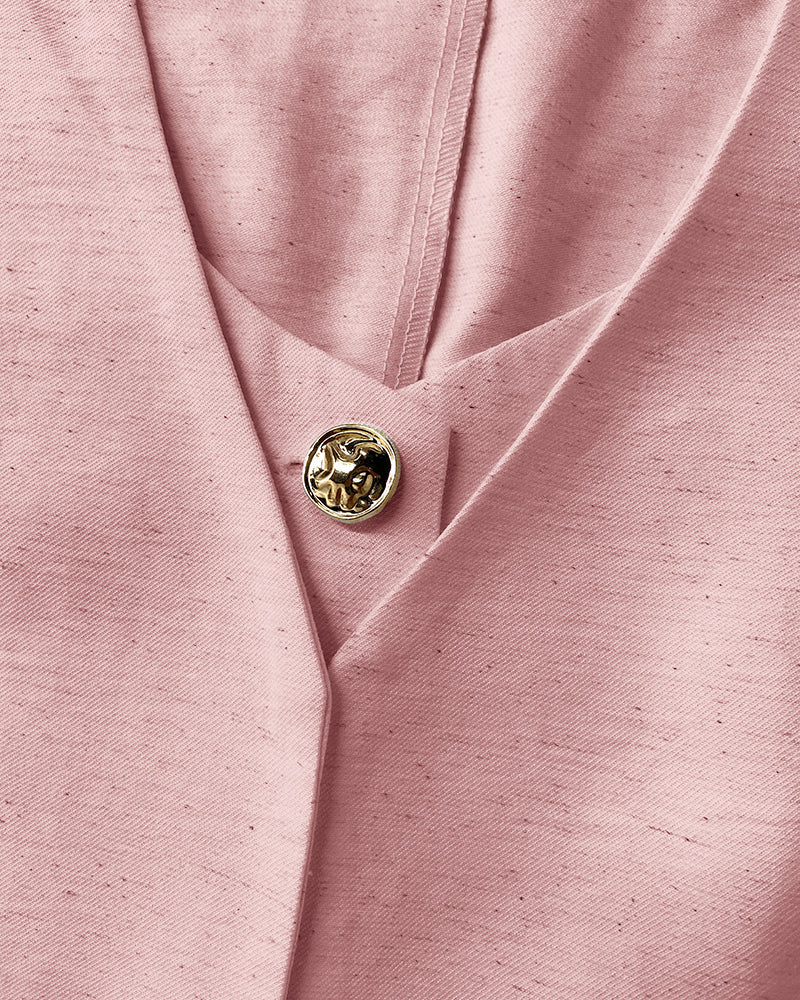Pink V-neck vest crop top with gold button, paired with matching wide-leg pants.