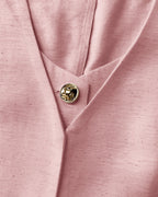 Pink V-neck vest crop top with gold button, paired with matching wide-leg pants.