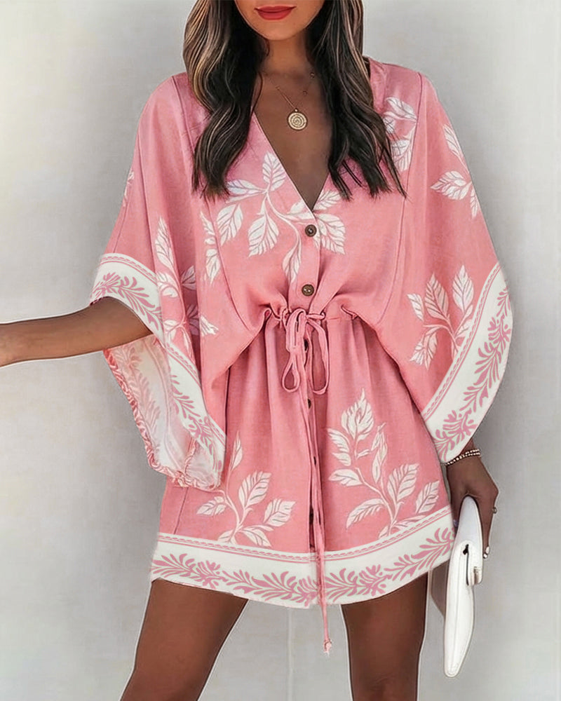 A floral V-neck mini dress with bell sleeves and a drawstring waist.