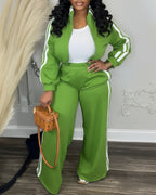 Green zip-up crop coat and wide-leg pants with white stripes, paired with white top.