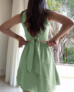 Square neck thick strap textured romper with tie back, skort design, back cutout, bow.