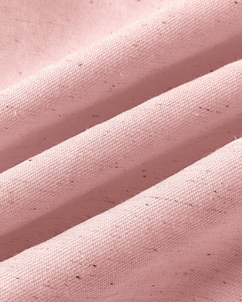 Soft, light pink textured fabric with gentle folds on wide-leg pants and V-neck vest top.