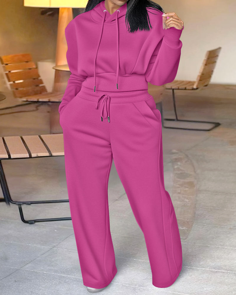 Bright pink 2-piece hoodie and wide-leg pants set with thumbholes, drawstring waist, pockets.