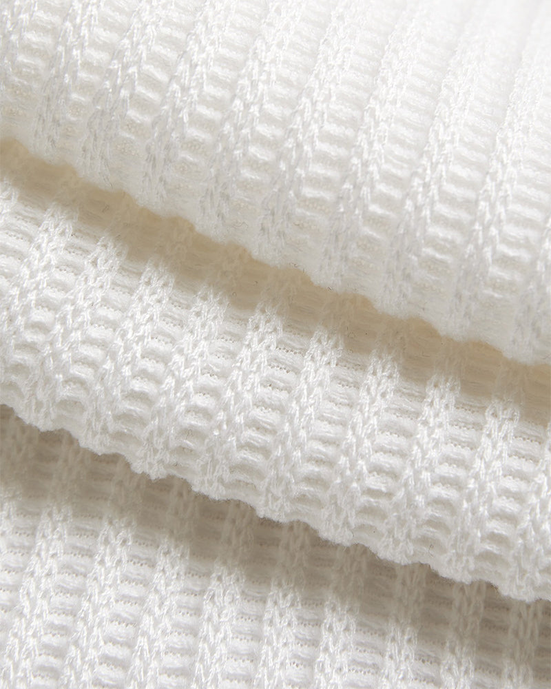 White ribbed knit hoodie with horizontal textured lines and asymmetrical hem, button-front design.