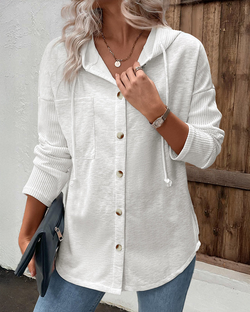 LA FINE FLEUR  long sleeve ribbed button-front hoodie with asymmetrical hem coat and blue jeans.