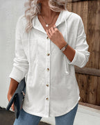 LA FINE FLEUR  long sleeve ribbed button-front hoodie with asymmetrical hem coat and blue jeans.