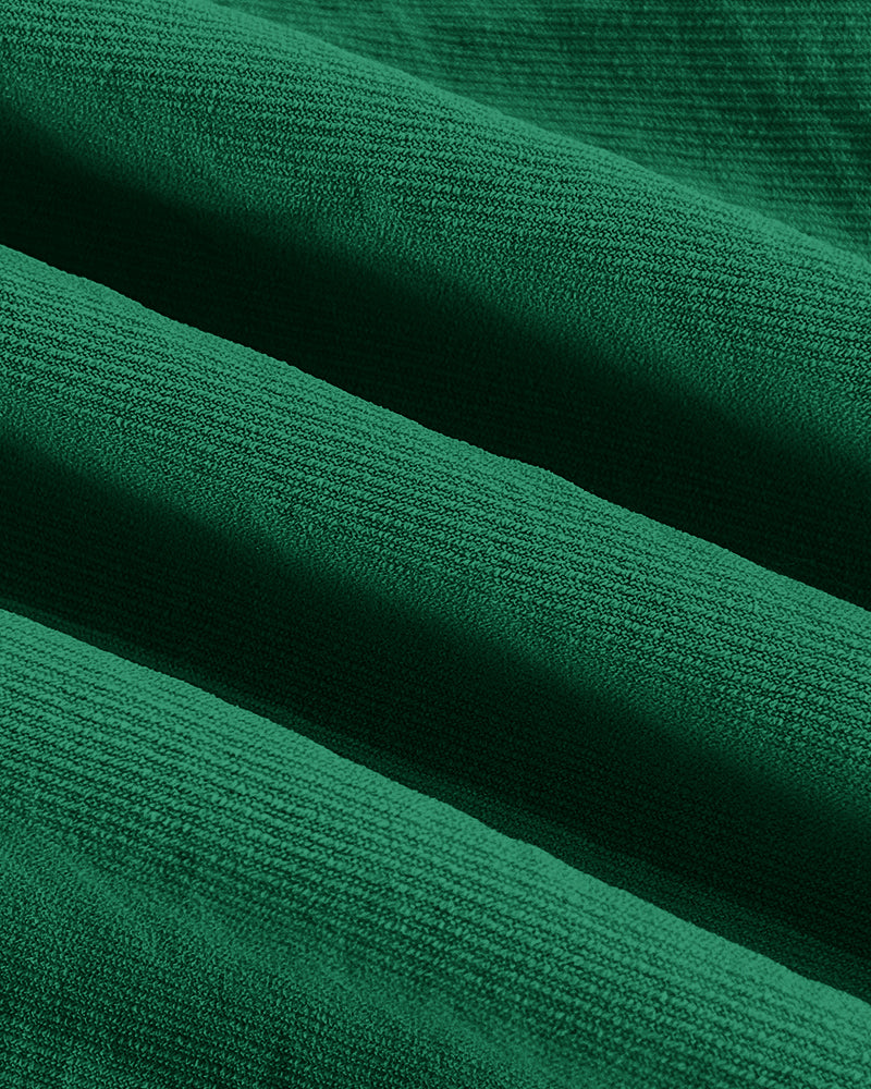 Close-up of green textured blouse and wide leg pants with ridges and diagonal lines.