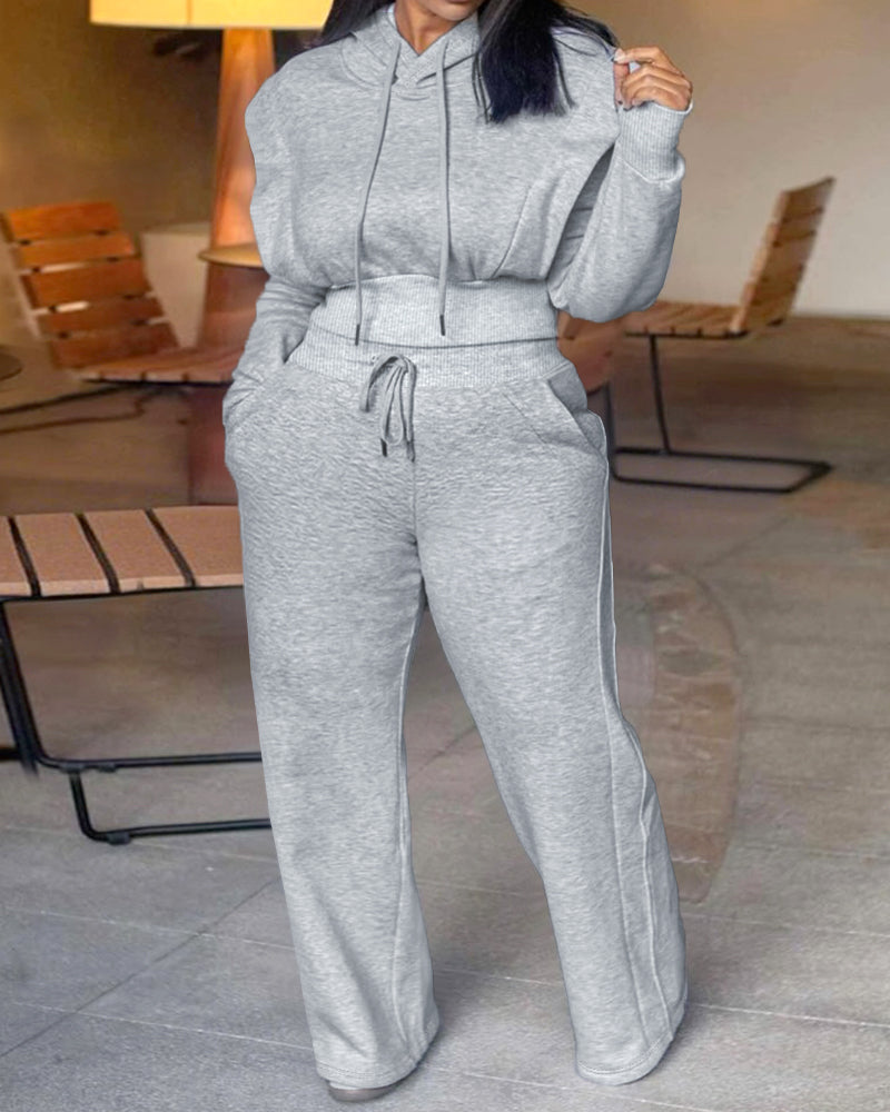 Light gray long sleeve hoodie with thumbholes paired with matching wide-leg pants set.