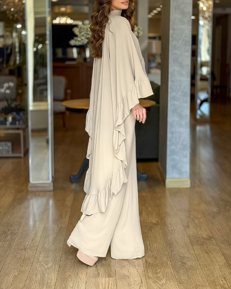 A 2-piece set featuring a high neck cape with ruffles and wide-leg pants.