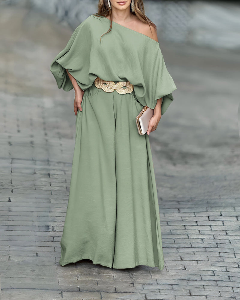 A skew neck lantern sleeve blouse paired with wide leg pants from LA FINE FLEUR.