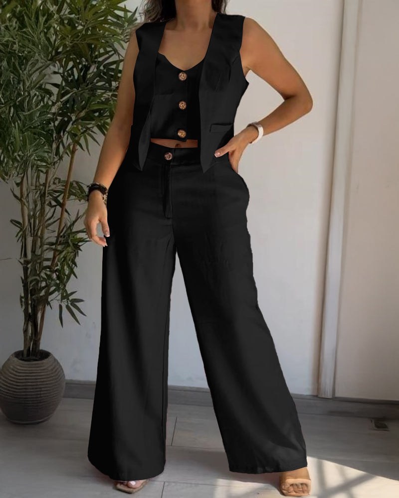 A V-neck vest crop top paired with high-waisted wide-leg black pants.