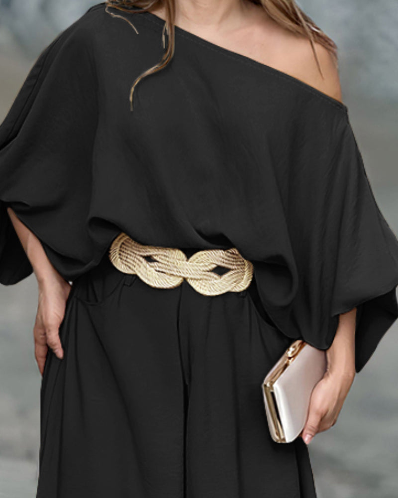 Skew neck lantern sleeve blouse with wide leg pants in an off-the-shoulder style.