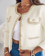 The LA FINE FLEUR  Pearl Button Fluffy Cardigan with Contrast Trim over a white crop top and blue jeans.