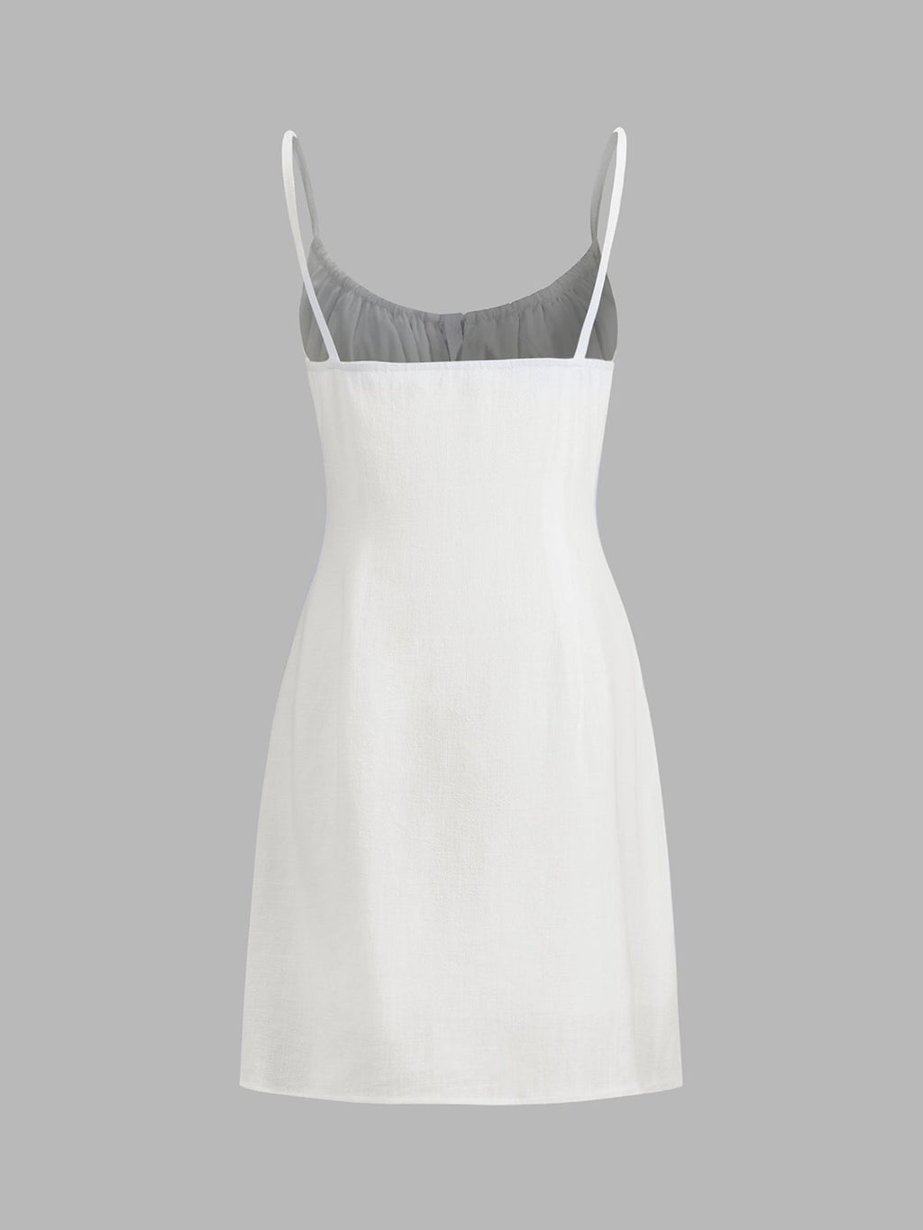 A sleeveless white linen mini dress with thin straps and a fitted, knee-length silhouette.