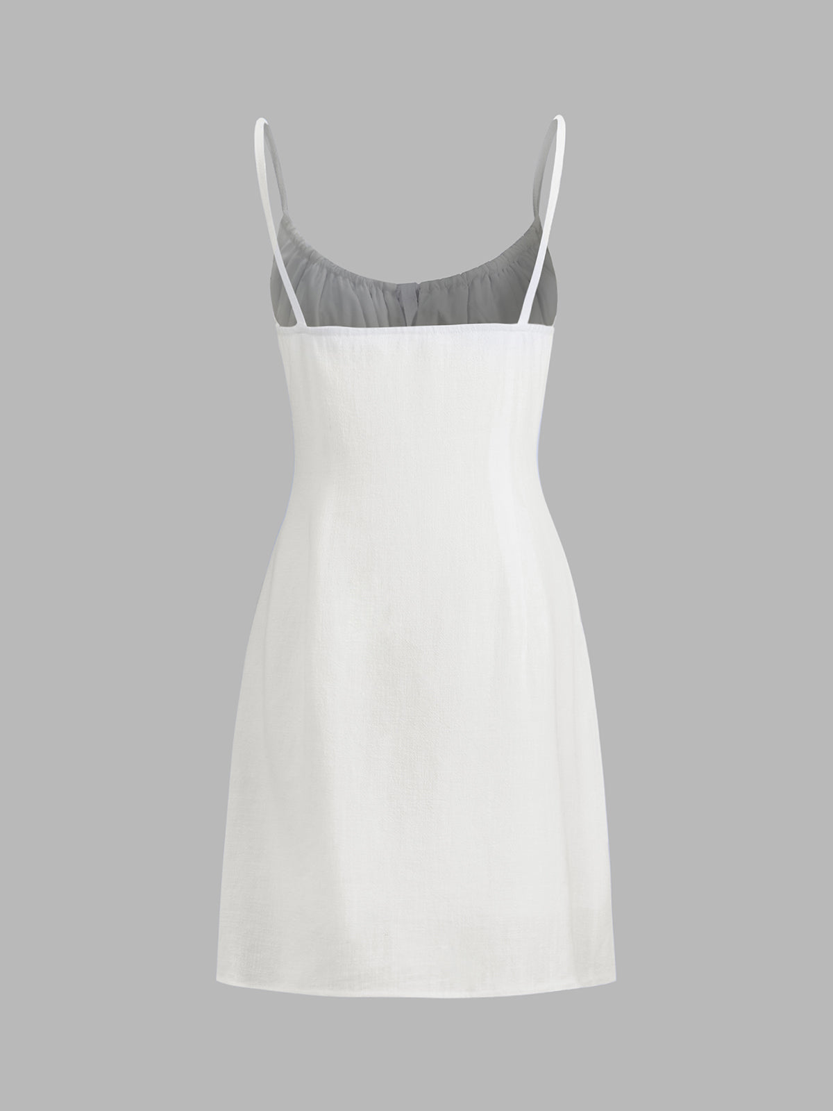 A sleeveless white linen mini dress with thin straps and a fitted, knee-length silhouette.