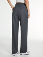 LA FINE FLEUR Airstream Tailored Straight-Leg Dress Pants in gray with white sneakers.