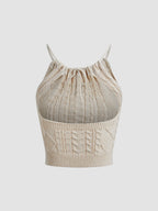Beige cable-knit halter crop top with open back, drawstring neckline, and ribbed hem.